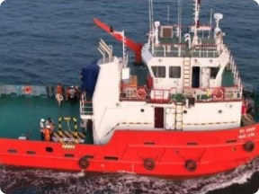 Red harbour tug under way