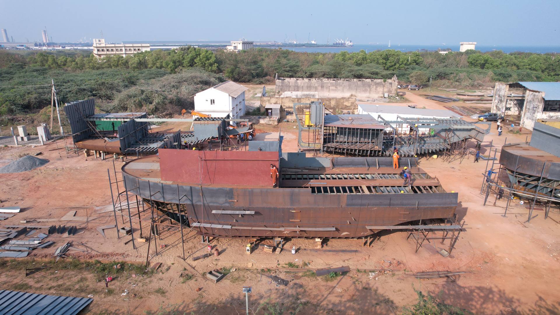 A steel hull taking shape in the yard