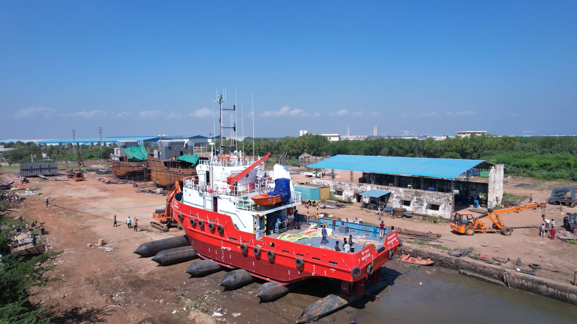 Aerial view of a red tug being prepared for launch