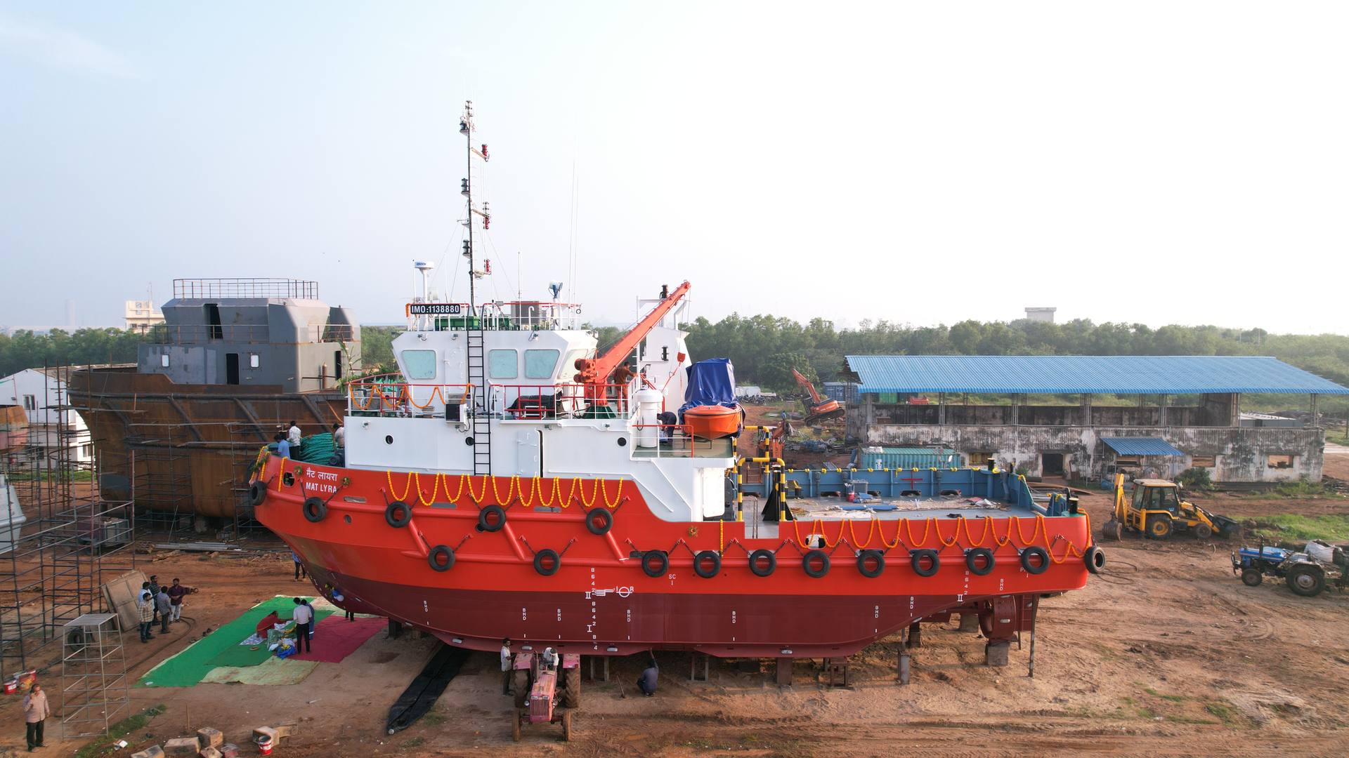 A red and white tug on the slipway at the Bluebay yard
